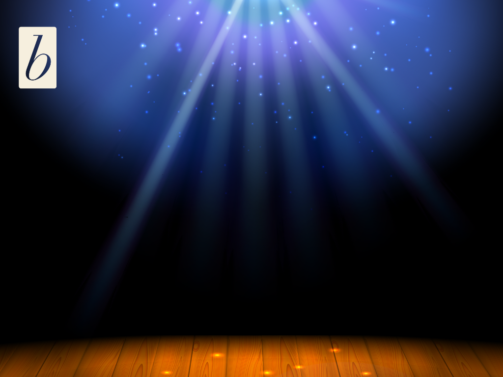 White rays of light shine down in front of a dark blue background, onto a brown wooden stage